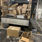 Commercial loading bay clearance with boxes and packaging loaded onto a vehicle