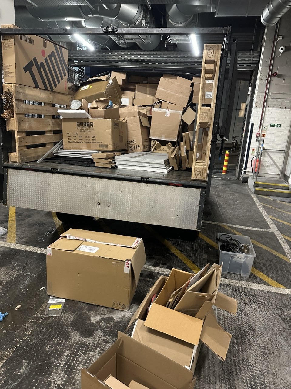 Commercial loading bay clearance with boxes and packaging loaded onto a vehicle